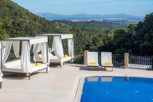a patio with chairs and a swimming pool at Finca Albellons in Binibona