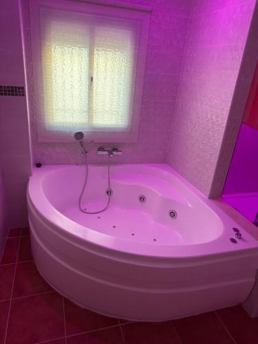 una vasca bianca in un bagno con finestra di Casa Rural Villa Briar a Olvera