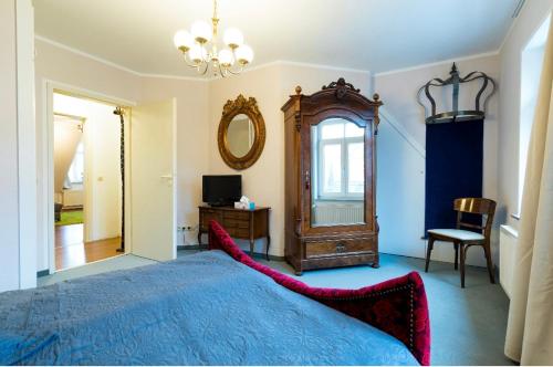 1 dormitorio con cama, espejo y silla en Altstadt Lennep - Schicke Wohnung en Remscheid