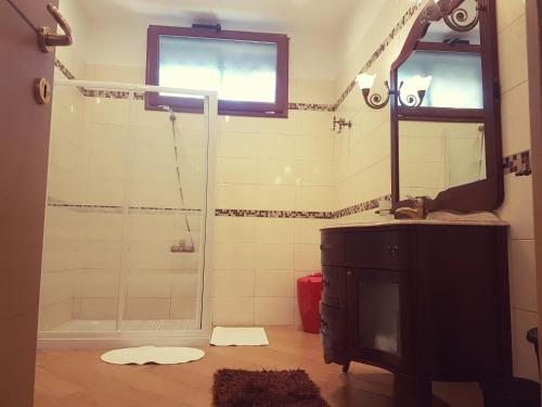a bathroom with a shower and a sink and a mirror at Airport Rooms - Bari in Bari