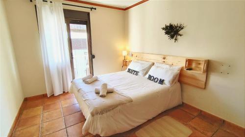 a bedroom with a bed with two towels on it at El Bosque Suites&Room By Mila Prieto in El Bosque