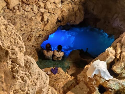 two women sitting in the water in a cave at Azcapri Villa Boutique & Spa in Cancún