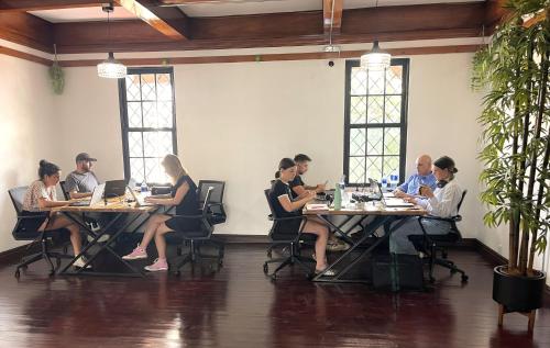 a group of people sitting at tables in a room at Costa Rica Guesthouse in San José