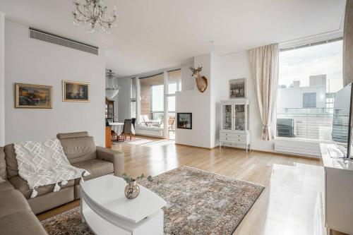 un soggiorno con divano e tavolo di Spacious Home With four Terrace, Sauna, Sea View a Helsinki