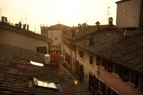 an overhead view of roofs of buildings in a city at Mariposa Apartments in Bardolino