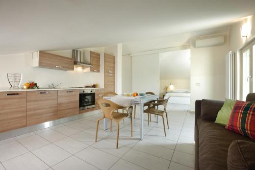 バルドリーノにあるMariposa Apartmentsのキッチン、リビングルーム(テーブル、椅子付)