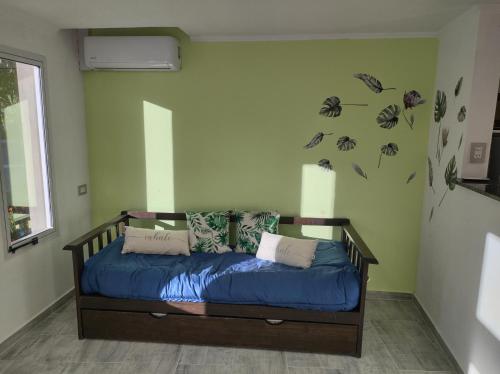 a bed in a room with flowers on the wall at costanera departamento in Viedma