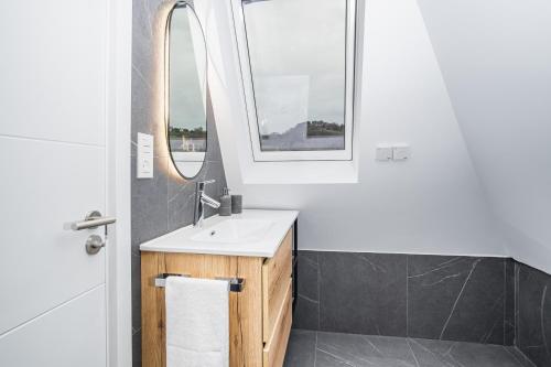 een badkamer met een wastafel en een spiegel bij ARROKAGAIN HOME in Hondarribia