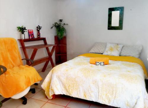 a bedroom with a bed and a chair at Home Sweet Home Guanajuato in Guanajuato