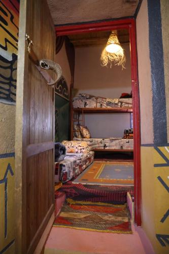 a room with two bunk beds and a doorway at Hike and Chill Homestay in Tinerhir