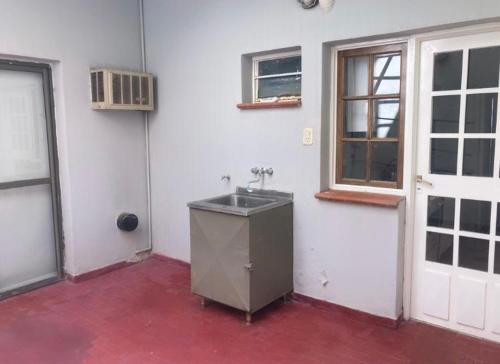 a white room with a sink and a window at Depto Centro in San Luis