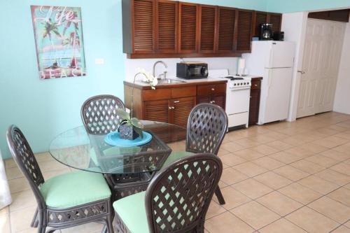 a kitchen with a glass table and chairs and a kitchen with a refrigerator at Point Pleasant Resort in Nazareth