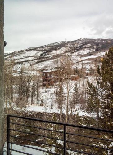 a view of a snow covered hill with a house at Cozy- Mountain Style - River View apartment - Colorado in Silverthorne