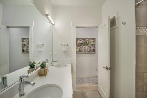 a white bathroom with two sinks and a shower at Cozy- Mountain Style - River View apartment - Colorado in Silverthorne