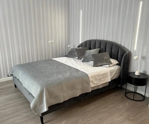 a bedroom with a large bed with pillows on it at Maia Grand Studio Bucharest in Bucharest