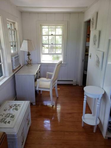 a room with a desk and a chair and a table at Scallop's Nest in Dennis Port