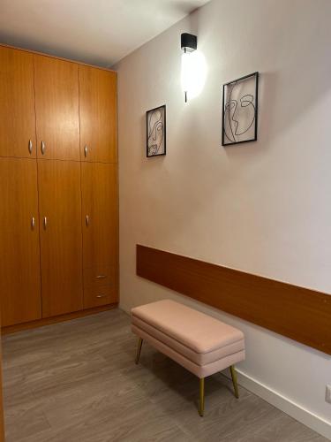 a waiting room with a bench and cabinets at Maia Grand Studio Bucharest in Bucharest