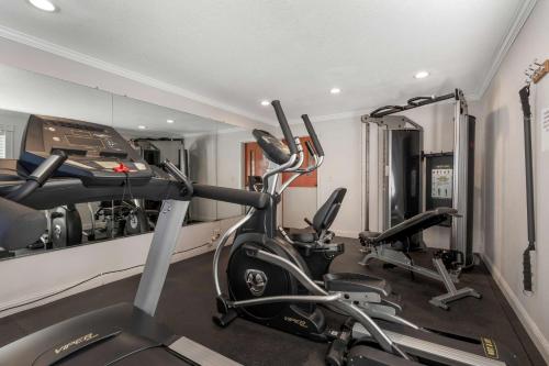 a gym with several treadmills and elliptical machines at Best Western Colonial Inn in Selma