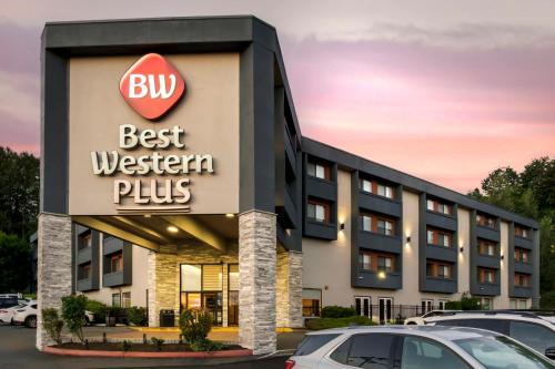 a building with a best western plus sign in a parking lot at Best Western Plus Renton Inn in Renton