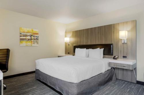 a hotel room with a large bed and a desk at Best Western Plus Renton Inn in Renton
