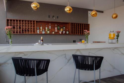two chairs sitting at a bar in a restaurant at Holiday Inn Express Mexico City Satelite by IHG in Mexico City