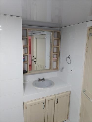 a bathroom with a sink and a mirror at Lavish Condo @Carlos Residential in Sosúa