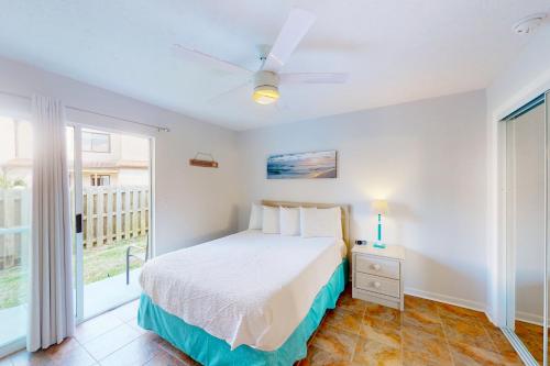 a white bedroom with a bed and a window at Wendwood Condominiums F2 in Panama City Beach