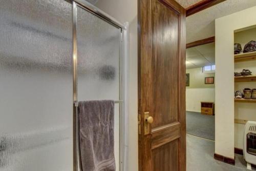 a bathroom with a shower with a glass door at Beautiful Midtown Retreat, Hot Tub, Blackstone,cws in Omaha