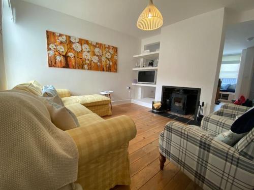 a living room with two couches and a fireplace at Cowes Cottage in Cowes
