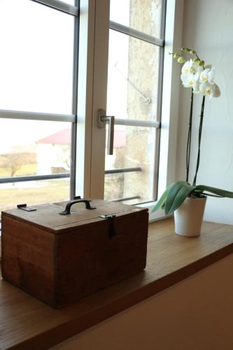 a wooden box sitting on a window sill with a flower at La Ferme de la Praz - Rooms with a View in La Praz