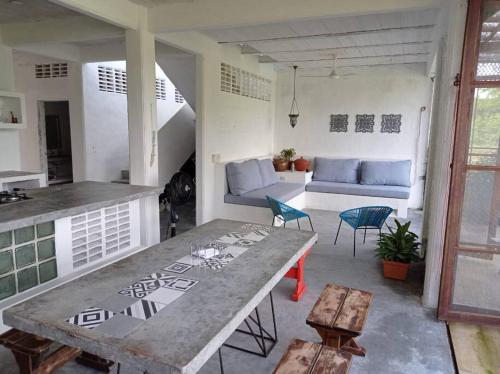 a living room with a table and a couch at Casa de Recreo - Vacation House in Honda