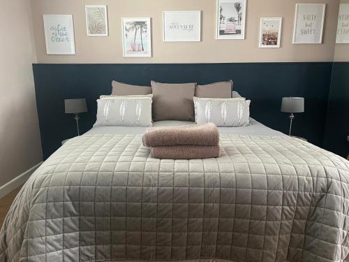 a bedroom with a large bed with a blue wall at Forever Summer in Lymington