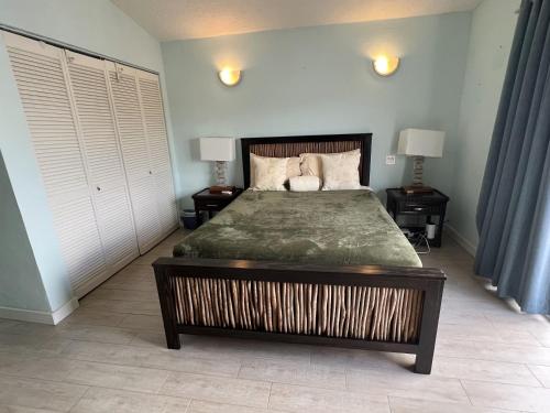 a bedroom with a large bed with two night stands at Sunny Villa in the Marina - Excellent Water Views in Jolly Harbour