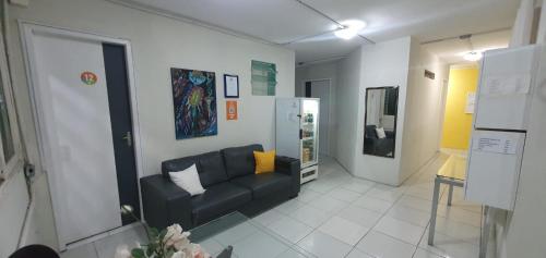 a living room with a couch in a room at Casa da Esquina Pousada in Recife