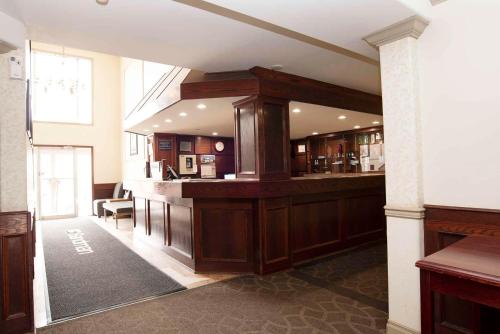 a large lobby with a bar in a building at Sandman Inn Smithers in Smithers