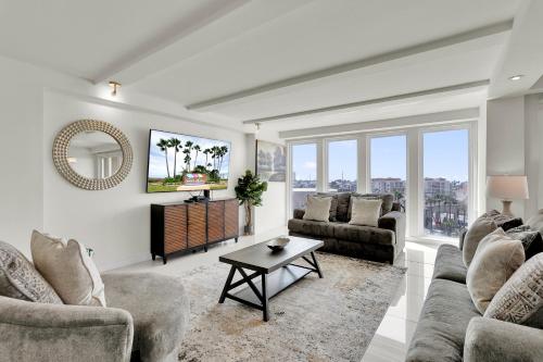 a living room with couches and a table at Stunning Bayview! Large condo in beachfront resort with shared pools and jacuzzi in South Padre Island