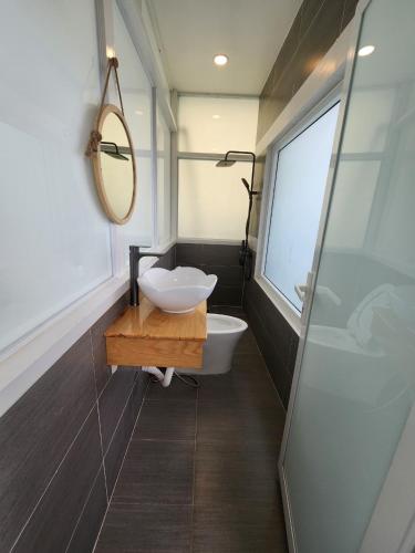 a bathroom with a white sink and a mirror at Khách sạn Vân Nhi in Bạc Liêu