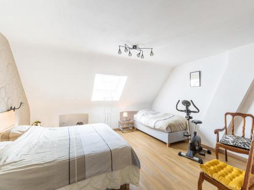 a bedroom with two beds and a camera in it at Charming Cottage with Sauna in Audregnies