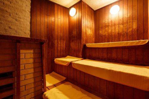 a sauna with two sinks and a shelf and lights at Hatori in Kaga