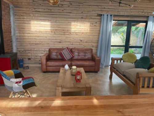 uma sala de estar com sofás e uma mesa de centro em Casa Divisadero en la Patagonia em Coihaique