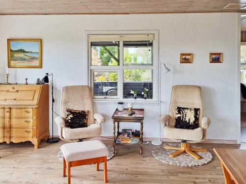 a living room with two chairs and a table at 7 person holiday home in Højslev-By Traum in Højslev