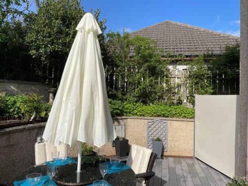 a white umbrella sitting on top of a table at The Apartment in Nairn