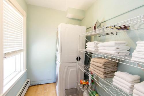 a closet with towels and a refrigerator at Melrose 5-bedroom house in Melrose