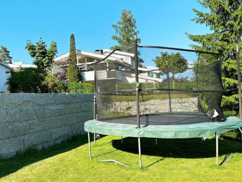 a metal trampoline in the grass in a yard at 9 person holiday home in NESØYA-By Traum in Sandvika