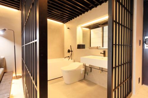 a bathroom with a toilet and a sink at Amanecer Hotel in Tokyo
