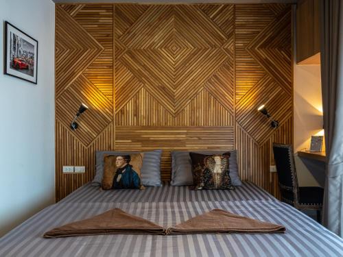 a bedroom with a bed with a wooden wall at The Diamond 789 Minburi in Bangkok