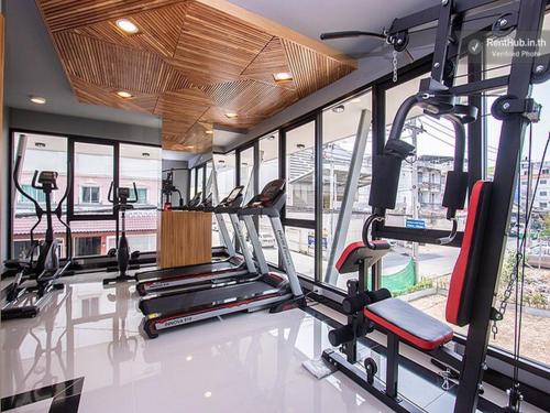 a gym with treadmills and ellipticals in a building at The Diamond 789 Minburi in Bangkok
