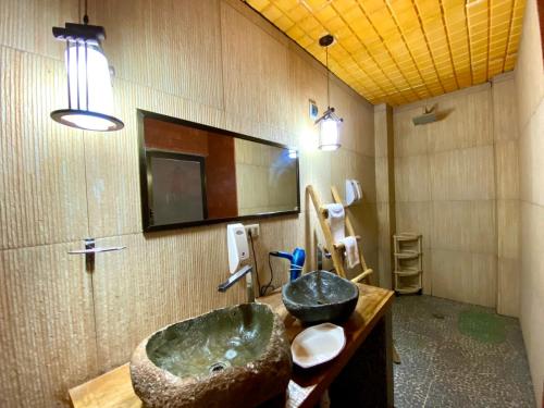 a bathroom with a large sink and a mirror at Casa de Sal - Salt Hotel in Uyuni