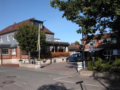 a parking lot in front of a building at Alter Dorfkrug Am Kanal in Wolfsburg