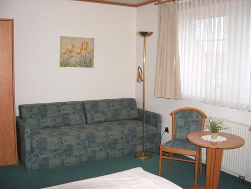 a living room with a couch and a table at Alter Dorfkrug Am Kanal in Wolfsburg